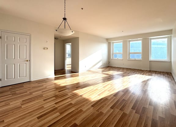 A room with wooden floors and a white door.