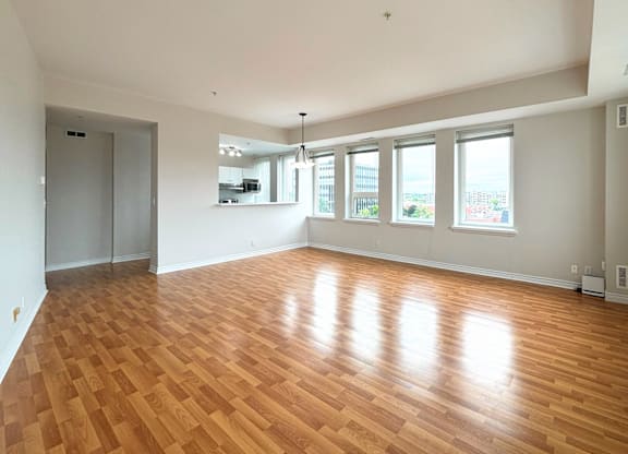 A large empty room with wooden floors and white walls.