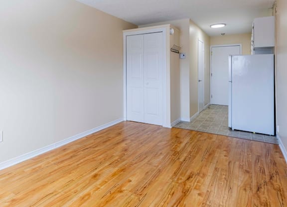 A room with wooden floors and white walls.