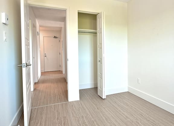 A room with a white door and a white wall.