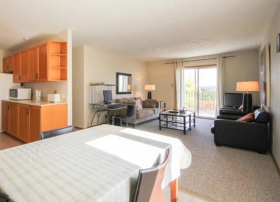 A bedroom with a bed, couch, and television.