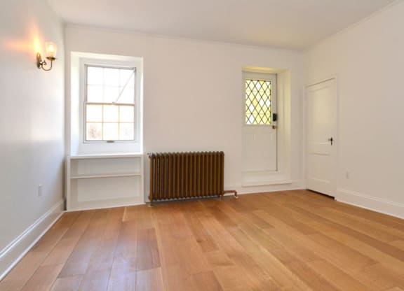 A room with a window and a door.
