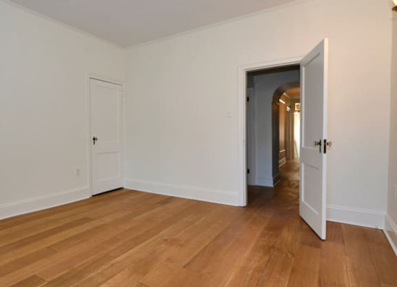A room with a wooden floor and white walls.