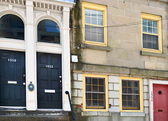 A building with a red door and a blue door with the number 1350 on it.