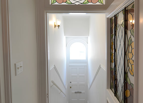 A staircase with a glass window in the middle.