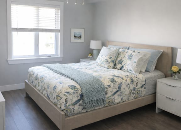 A bedroom with a large bed and a ceiling fan.