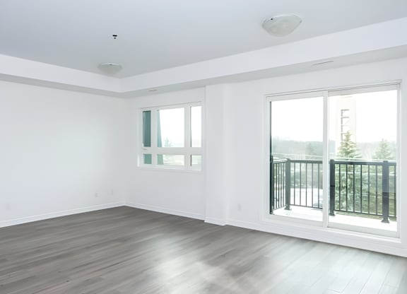 A room with a window and a balcony.