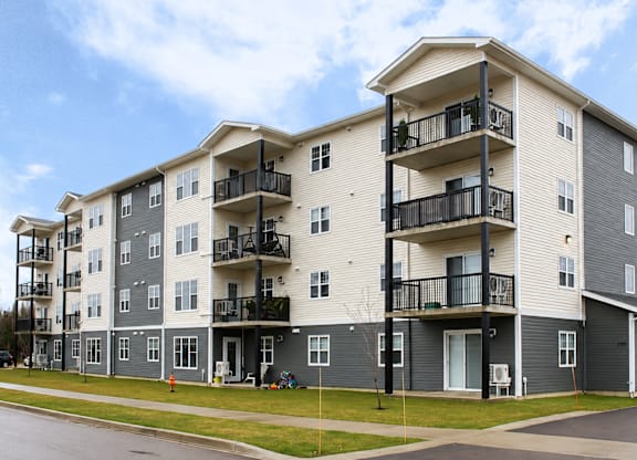 Apartment building with balconies and doors.