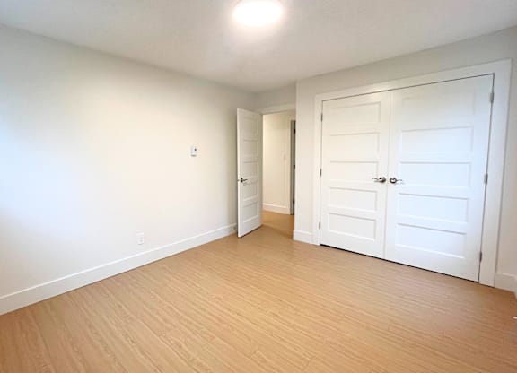 A room with a white door and a white wall.