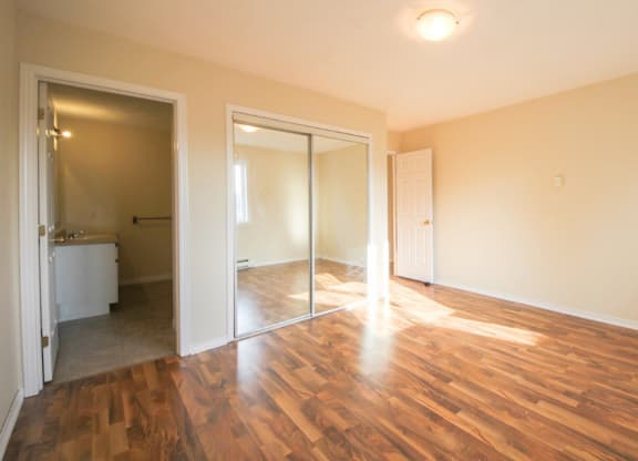 A room with wooden floors and a white door.