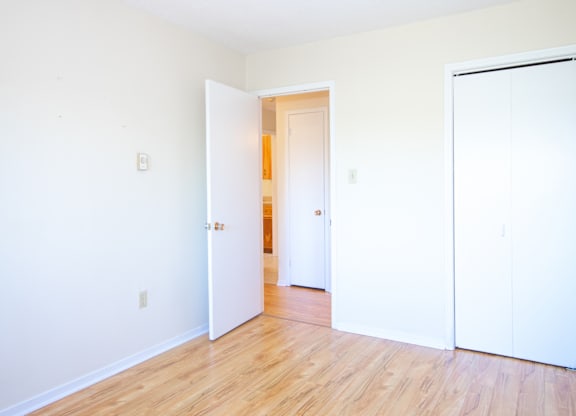 A room with a white door and a white wall.
