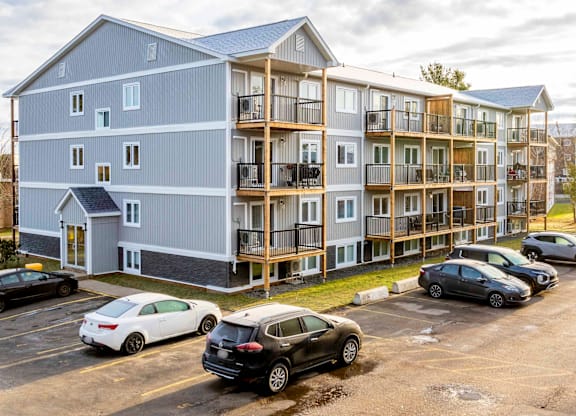 A large building with a parking lot in front of it.