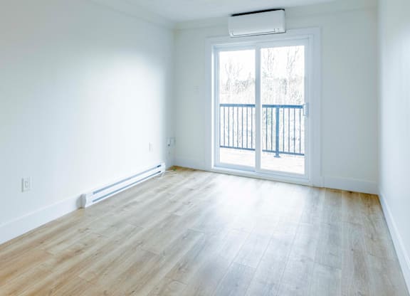 A room with a window and a balcony.