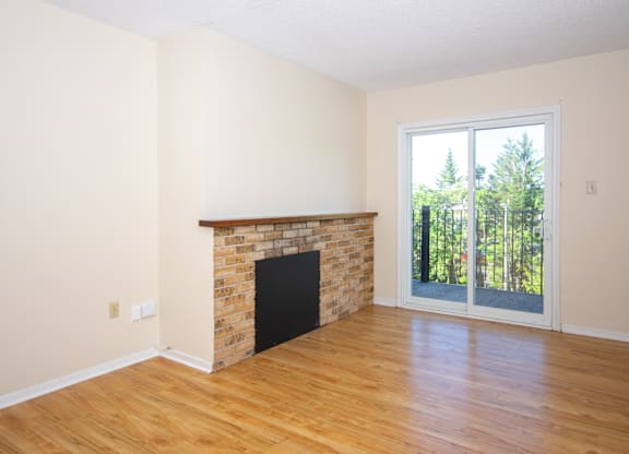 A room with a fireplace and sliding glass doors.