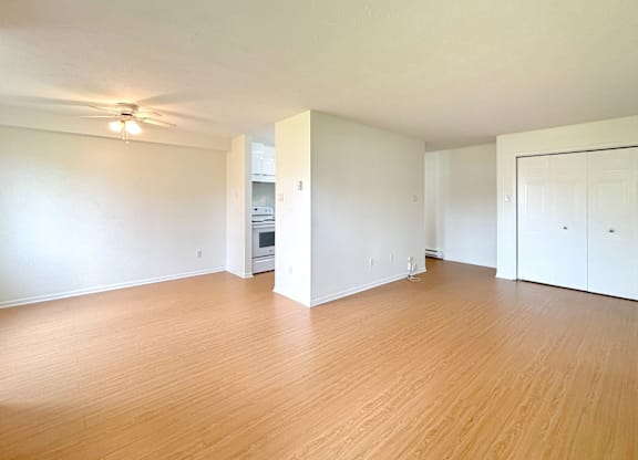 A room with wooden floors and a ceiling fan.