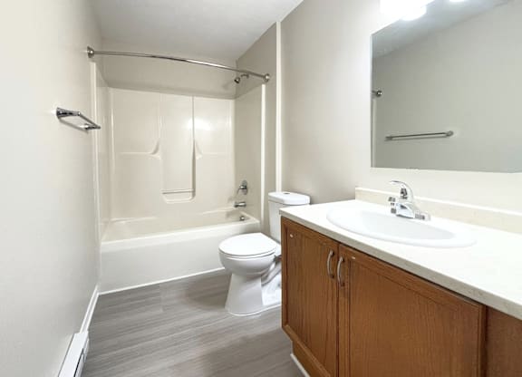 A white toilet sits next to a sink in a bathroom.