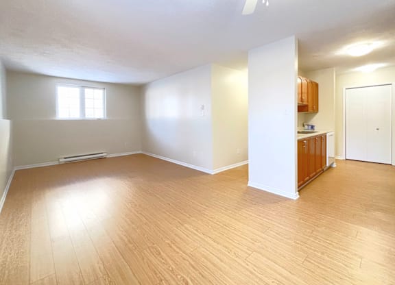 A room with wooden floors and a ceiling fan.