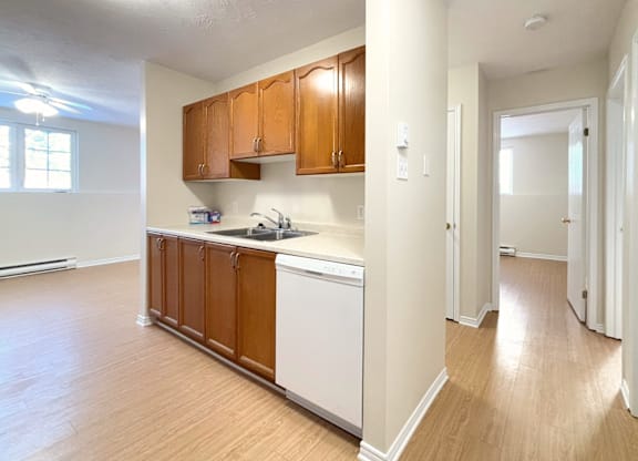 A kitchen with wooden cabinets and white appliances.