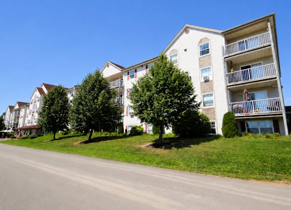 Apartment building with a tree in front of it.