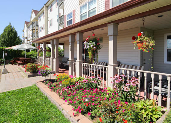 A building with a flower garden in front.