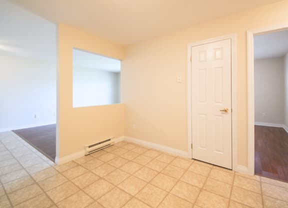 A room with a white door and a window.