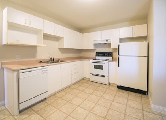 A kitchen with white appliances and cabinets.