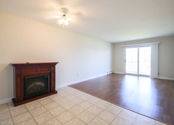 A room with a fireplace and tile flooring.