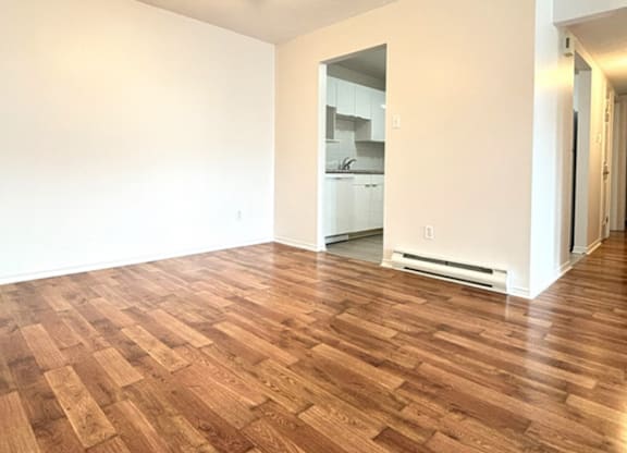 A room with wooden flooring and a ceiling fan.