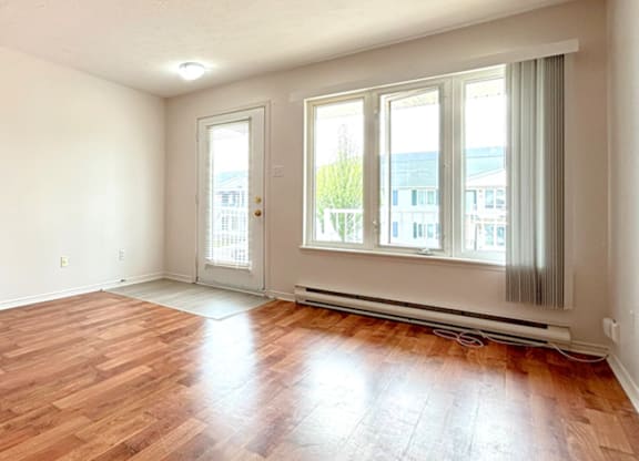 A room with wooden floors and white walls.