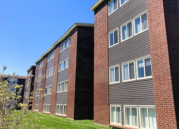 A building with a grey facade and a brick chimney.