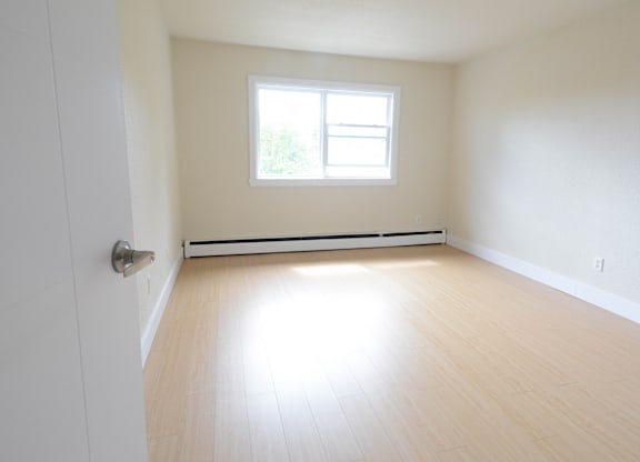 A room with a window and a door.