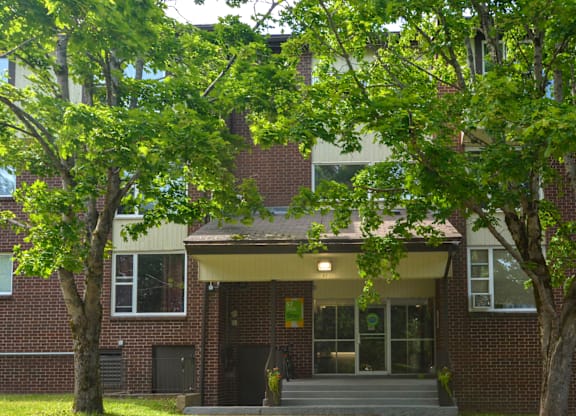 A building with a brick facade and a covered entrance.