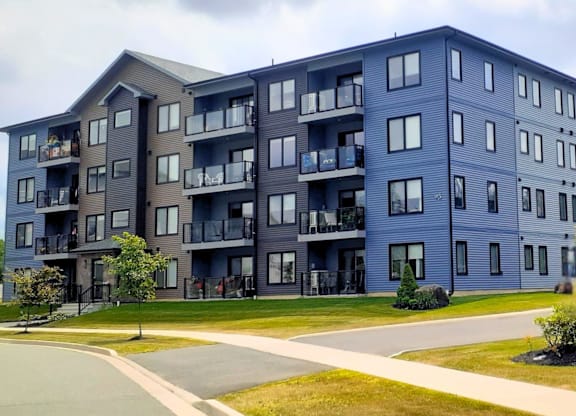 A large apartment building with balconies and multiple windows.