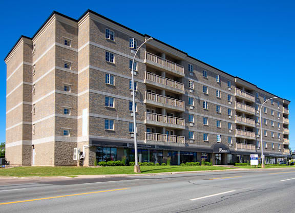 A large apartment building with a balcony on the second floor.