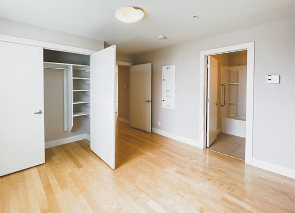 A room with a white door and a white wall.
