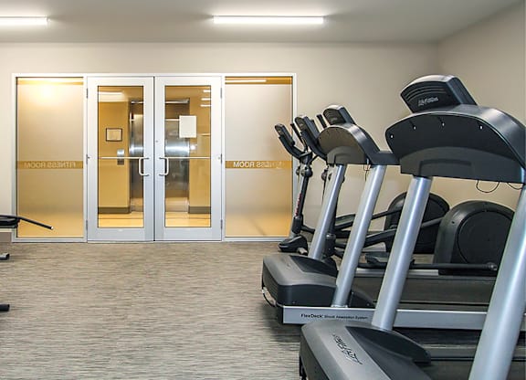 A gym with treadmills and a sign that says "moonwalk".