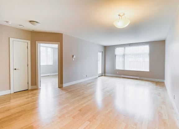 A room with wooden floors and white walls.
