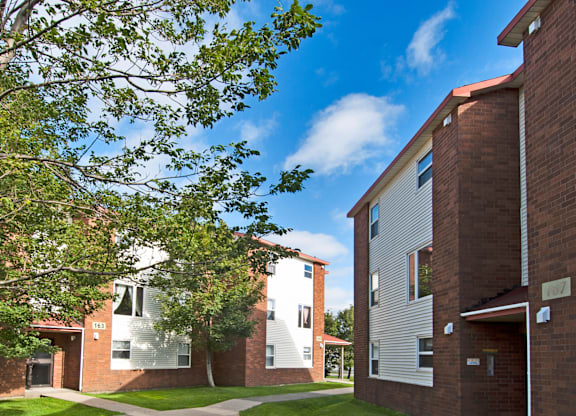 A building with a red brick exterior and a white door.