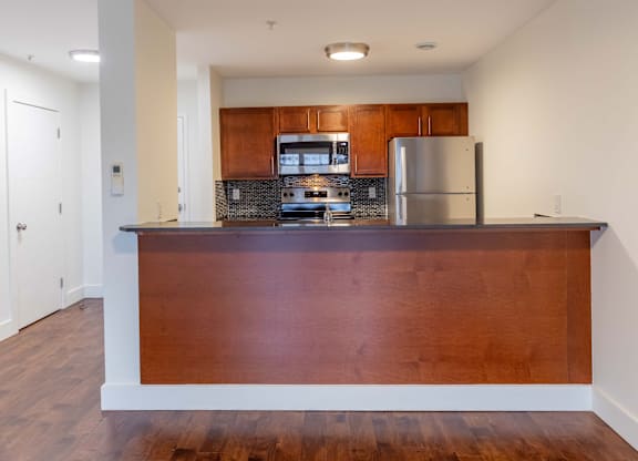 A kitchen with a wooden counter and stainless steel appliances.