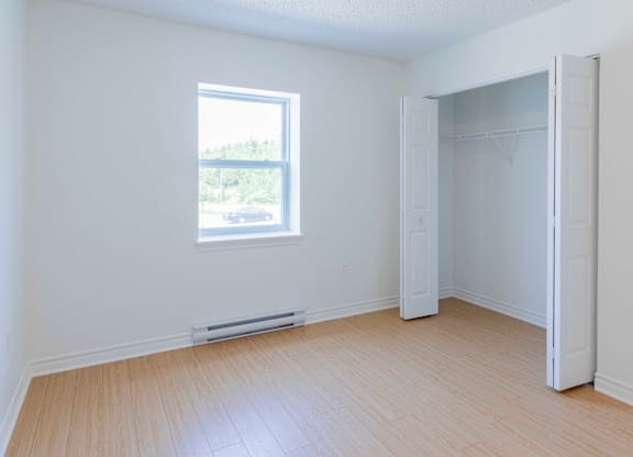 A room with a window and a door.