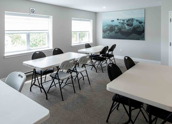 A conference room with a long table and chairs.