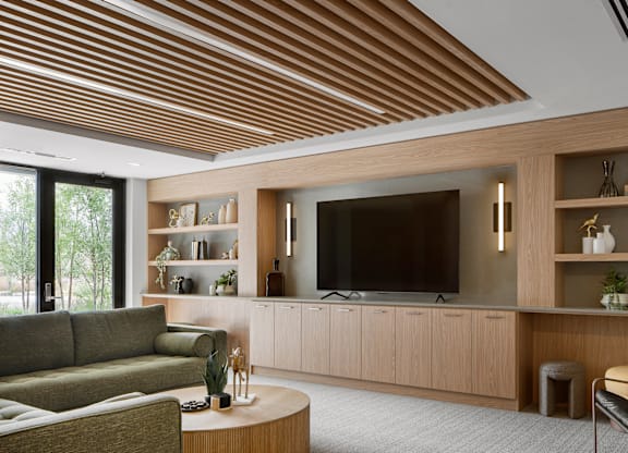 A modern living room with a large flat screen TV and a wooden ceiling.