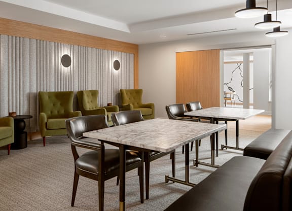 A modern dining room with a large table and chairs.