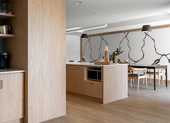 A modern kitchen with wooden cabinets and a central island.
