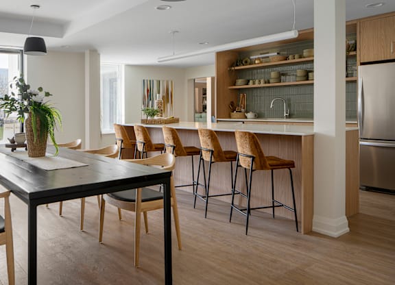 A modern kitchen with a dining table and chairs.