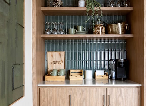 A kitchen shelf with a variety of items including a sign that says "BERTANT".