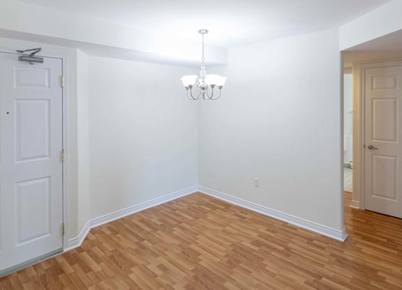 A room with a chandelier and a white door.