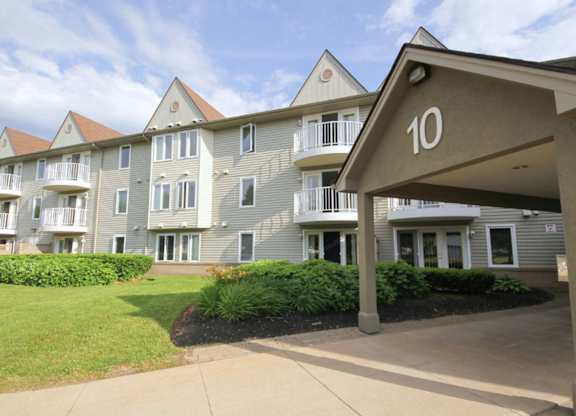 Apartment building number 10 with a green lawn in front.