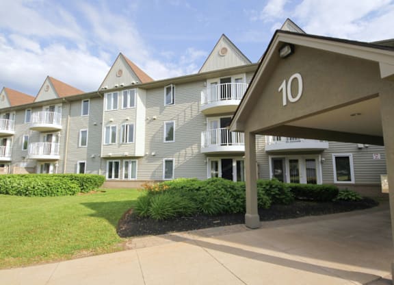 Apartment building number 10 with a green lawn in front.