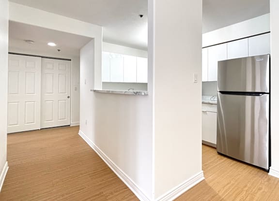 A kitchen with a refrigerator and a countertop.